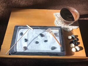 photo of zen sand with rakes and small stones