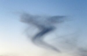 photo of the sky with an abstract image of a person created by a cloud.